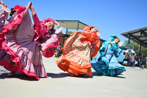 Traditional Mexican folklórico dancers twirl their dresses during their performance at the Creative Rides Car Show at Norte Vista Highschool on May 18, 2024.