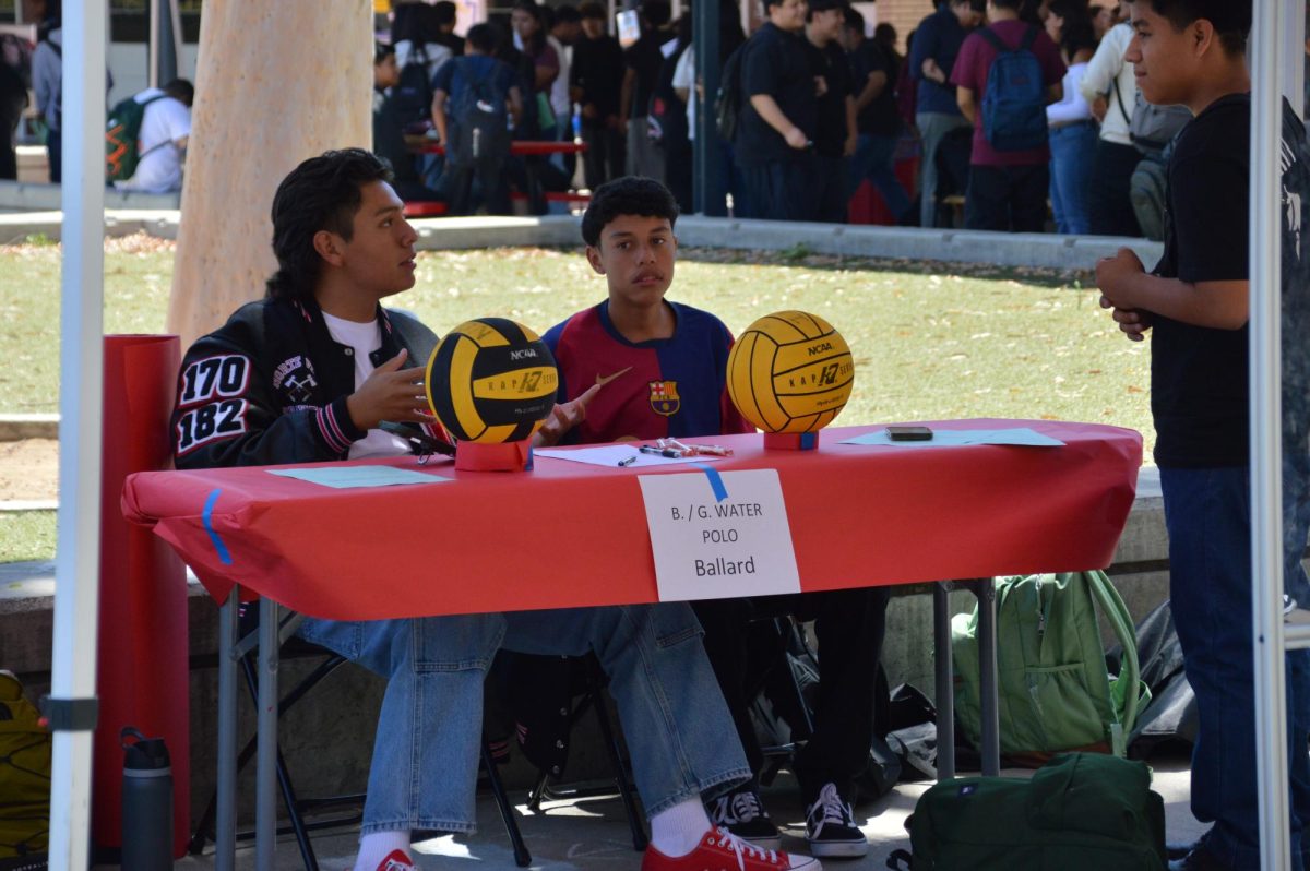 Kevin Adame and Daniel Muñoz recruit others into NOVI Aquatics at Club Rush on August 13, 2024.