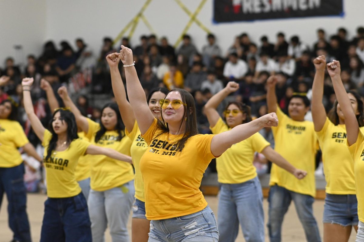 Students perform their dance for the homecoming assembly