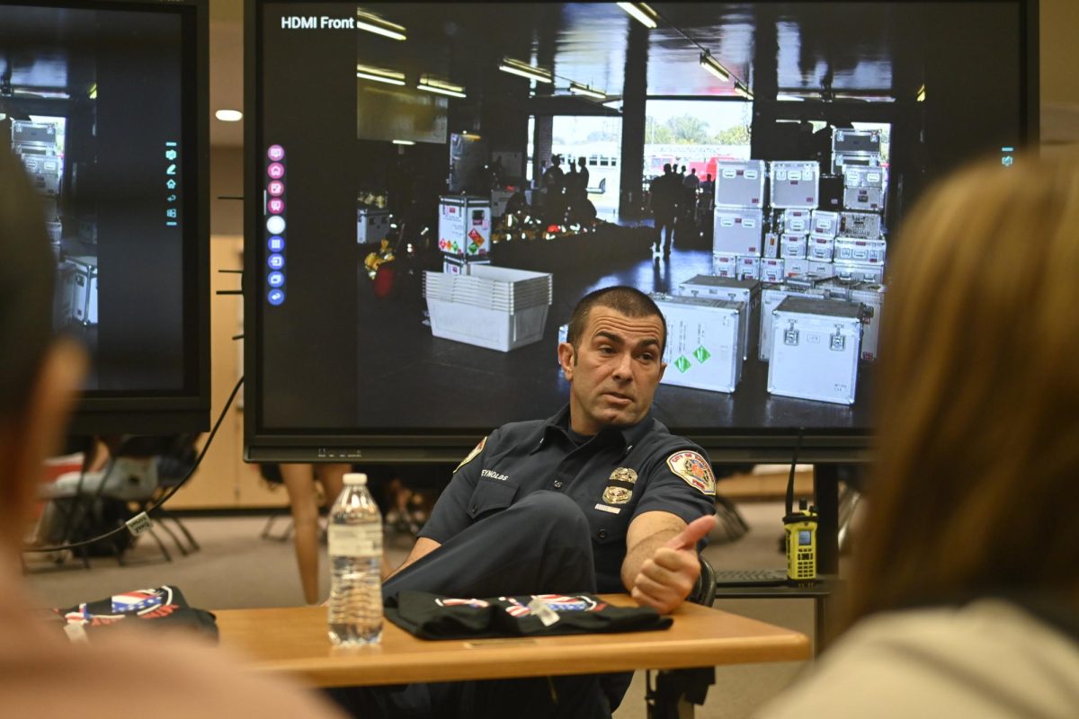 A firefighter sharing his experience with 9/11 to fellow students.