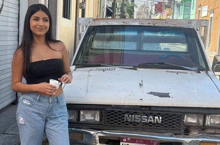 Eden Mendoza posing next to a car in Mexico