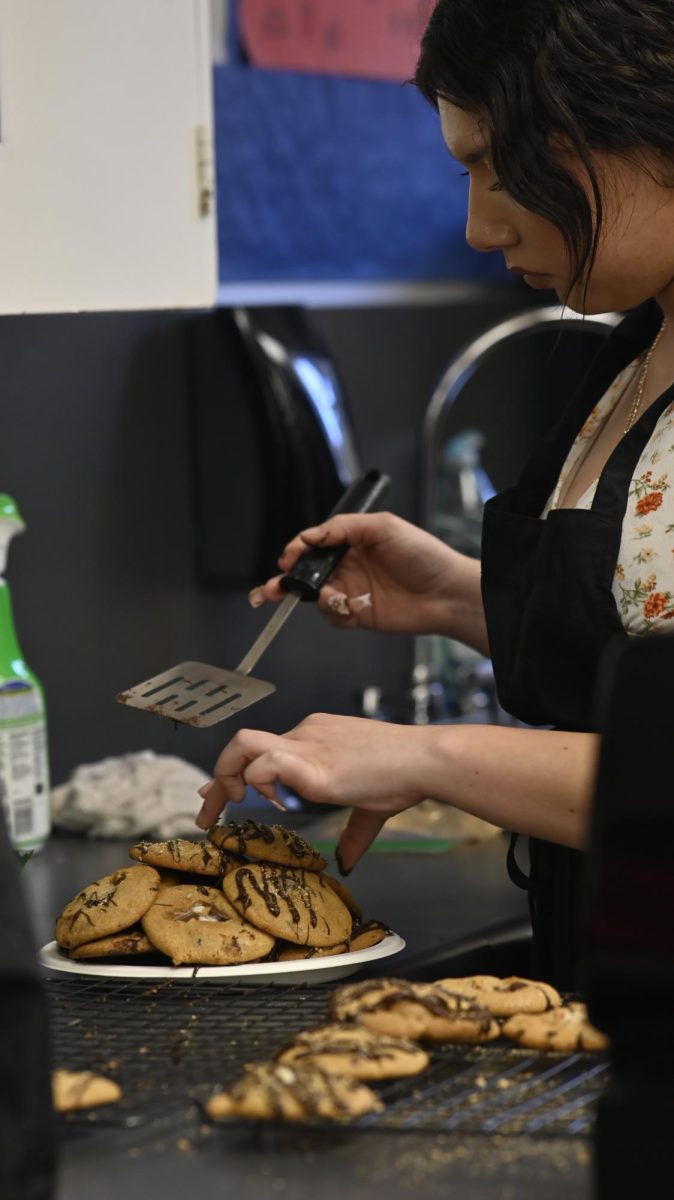 Madison Garibay Romero (12) placing her teams cookies on a plate